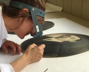 Conservator Luisa Casella treating crayon portrait